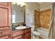 Bathroom with a tub, granite vanity and wood cabinets at 904 Charo Pkwy # 536, Davenport, FL 33897