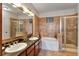 Bathroom with granite double vanity, soaking tub, and walk-in shower at 904 Charo Pkwy # 536, Davenport, FL 33897