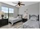 Well-lit bedroom with two twin beds and a ceiling fan at 904 Charo Pkwy # 536, Davenport, FL 33897