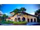 Community clubhouse with palm trees and landscaping at 904 Charo Pkwy # 536, Davenport, FL 33897
