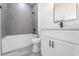 Clean bathroom with gray tile, white vanity, and bathtub at 2416 Sw 158Th Pl, Ocala, FL 34473
