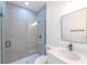 Modern bathroom with gray tile, glass shower, and white vanity at 2416 Sw 158Th Pl, Ocala, FL 34473
