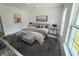Spacious main bedroom with large windows and stylish furniture at 2416 Sw 158Th Pl, Ocala, FL 34473