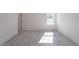 Spacious bedroom featuring gray vinyl flooring and a window at 2416 Sw 158Th Pl, Ocala, FL 34473