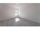 Well-lit bedroom with gray vinyl flooring and a window at 2416 Sw 158Th Pl, Ocala, FL 34473