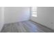 Bright bedroom with gray vinyl flooring and a window at 2416 Sw 158Th Pl, Ocala, FL 34473