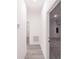 Bright hallway with gray vinyl flooring and access to garage at 2416 Sw 158Th Pl, Ocala, FL 34473