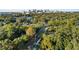 Elevated view of a vacant lot surrounded by mature trees, near a city skyline at 400 Raehn St, Orlando, FL 32806