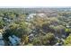 Two-story house surrounded by trees, aerial view showing nearby homes and street at 400 Raehn St, Orlando, FL 32806