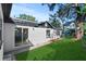Renovated home with a spacious backyard, lush lawn, and mature trees at 400 Raehn St, Orlando, FL 32806