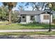 Renovated white brick home with a gray roof and manicured lawn at 400 Raehn St, Orlando, FL 32806
