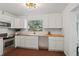 Modern kitchen with white cabinets, butcher block counters at 400 Raehn St, Orlando, FL 32806