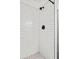 Clean shower with white subway tiles and black accents at 400 Raehn St, Orlando, FL 32806