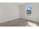 Minimalist bedroom featuring a large window providing natural light and a view of the outdoors at 4513 Sw 170Th Rd, Ocala, FL 34473