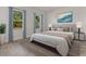 Comfortable main bedroom with neutral tones, a large bed, and bright windows with tree-lined views at 4513 Sw 170Th Rd, Ocala, FL 34473