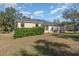 House with backyard, green hedge, and grass at 6689 Bell Glade Pl, Sanford, FL 32771