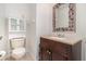 Compact bathroom with a single vanity sink, a toilet, and storage cabinet at 6689 Bell Glade Pl, Sanford, FL 32771