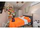 Bedroom with orange bedding and ensuite bathroom at 6689 Bell Glade Pl, Sanford, FL 32771