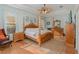 Spacious bedroom with a post bed, wood flooring, and large windows at 6689 Bell Glade Pl, Sanford, FL 32771