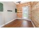 Bright bonus room featuring wood-paneled walls and a sliding glass door to the backyard at 6689 Bell Glade Pl, Sanford, FL 32771