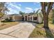 Two-story house with a driveway, landscaping, and mature trees at 6689 Bell Glade Pl, Sanford, FL 32771