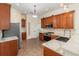 Well-equipped kitchen with stainless steel appliances, wood cabinets, and quartz countertops at 6689 Bell Glade Pl, Sanford, FL 32771