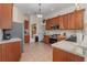 Modern kitchen with wood cabinets, stainless steel appliances, and tile floor at 6689 Bell Glade Pl, Sanford, FL 32771