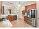 Modern kitchen with stainless steel appliances, granite countertops, and a view of the living room at 6689 Bell Glade Pl, Sanford, FL 32771