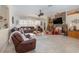 Spacious living room with a fireplace, comfortable furniture, and large windows at 6689 Bell Glade Pl, Sanford, FL 32771