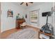 Home office with built-in desk and hardwood floors at 6689 Bell Glade Pl, Sanford, FL 32771