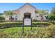 Lush landscaping adorns the clubhouse entrance, creating a welcoming and attractive community gathering space at 7321 Brightland St, Windermere, FL 34786