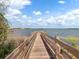 A picturesque wooden dock offers serene lake views and a peaceful spot to unwind, perfect for fishing or enjoying nature at 7321 Brightland St, Windermere, FL 34786