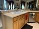 Light beige countertops, double sink, and light wood cabinets in this kitchen at 9111 Woodbridge Oak Ter, Orlando, FL 32825