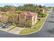 Aerial view of the townhome showcasing its landscaping, roof, and surrounding neighborhood at 100 Palermo St, Davenport, FL 33897