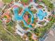 Aerial view of resort-style community pools and amenities with lush landscaping at 100 Palermo St, Davenport, FL 33897