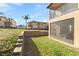 Image showcasing a screened-in porch and retaining wall in the backyard of a home at 100 Palermo St, Davenport, FL 33897