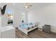 Bright bedroom with a ceiling fan, two windows, and a mini fridge at 100 Palermo St, Davenport, FL 33897