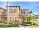 Charming two-story townhome with a well-manicured lawn and landscaping at 100 Palermo St, Davenport, FL 33897