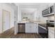 Bright, modern kitchen with stainless steel appliances and white cabinets at 100 Palermo St, Davenport, FL 33897