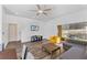 Cozy living room with sliding doors to patio and a ceiling fan at 100 Palermo St, Davenport, FL 33897