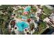 Aerial view of a resort pool with palm trees, sun umbrellas, and lounge chairs at 100 Palermo St, Davenport, FL 33897