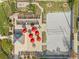Overhead view of volleyball court with chairs and red umbrellas on the side at 100 Palermo St, Davenport, FL 33897