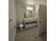 Modern bathroom with a large mirror, storage vanity, and tile flooring at 1210 Southstation Pl # 303, Orlando, FL 32809