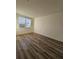 Cozy bedroom featuring wood-look floors and a window for natural light at 1210 Southstation Pl # 303, Orlando, FL 32809