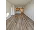 Spacious living room offers wood-look floors, neutral walls, and views into the kitchen at 1210 Southstation Pl # 303, Orlando, FL 32809