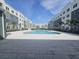 Community pool area with apartment building in the background at 1210 Southstation Pl # 303, Orlando, FL 32809