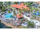 An aerial view showing a splash pool, playground, basketball court, and clubhouse with a terracotta roof at 167 Castaway Beach Way, Kissimmee, FL 34746
