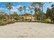 A sand volleyball court with an apartment building visible in the background on a bright day at 167 Castaway Beach Way, Kissimmee, FL 34746