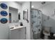 Clean bathroom with white vanity, shower, and nautical-themed decor at 5316 Pebble Beach Dr # E, Orlando, FL 32811