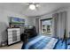 Comfortable bedroom with a large TV, desk, and blue striped bedding at 5316 Pebble Beach Dr # E, Orlando, FL 32811